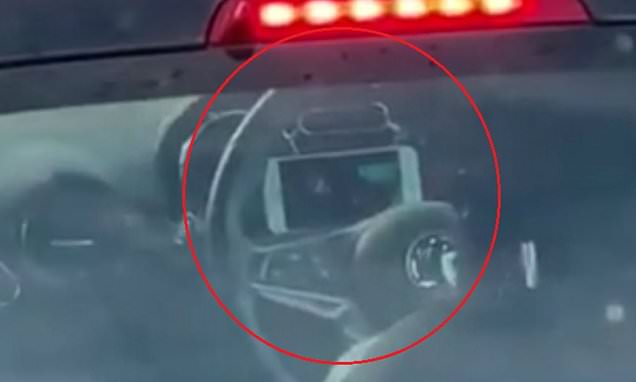 Manchester driver props her phone up on her dashboard to watch a FILM