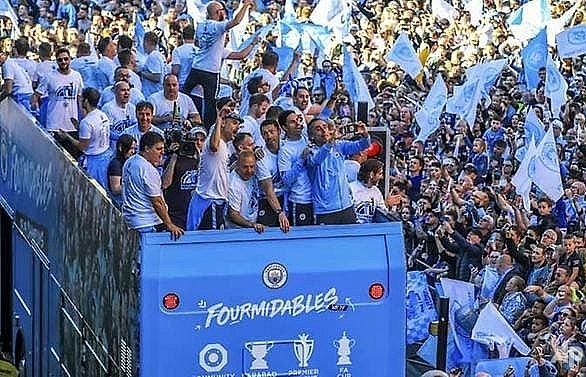 Treble winners Manchester City enjoy bus parade