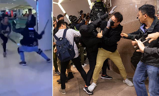 Horrifying moment man leaps 13 feet from second-floor balcony in shopping mall to escape police as Hong Kong protests turn violent again